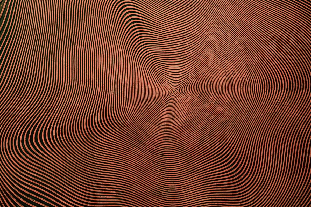 a red and black background with wavy lines